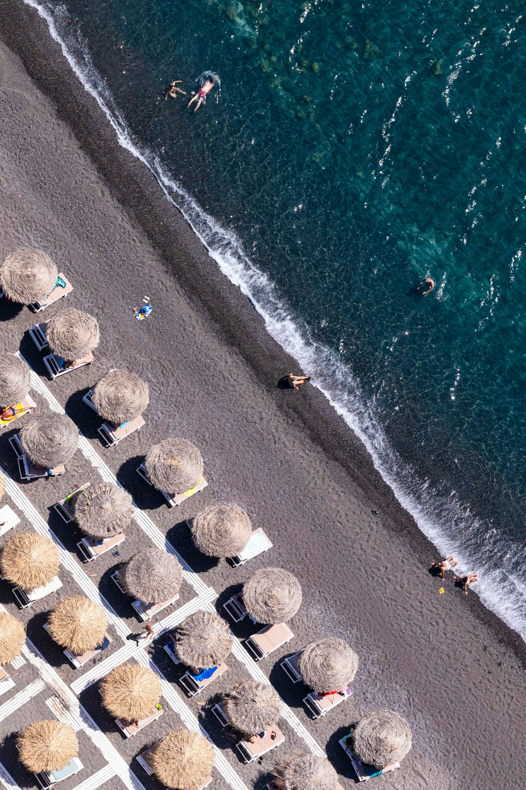 Photography by Gray Malin of Black Sand Beach, Mykonos