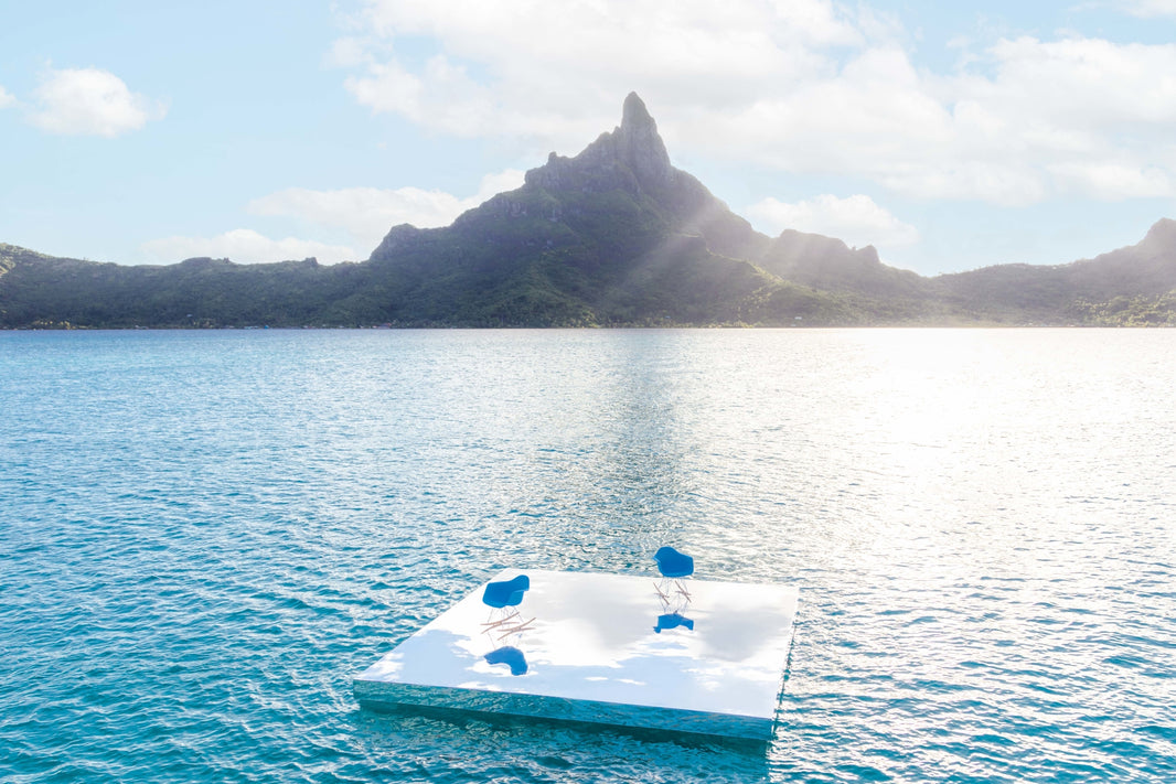 Photography by Gray Malin of Eames Molded Armchairs, Bora Bora