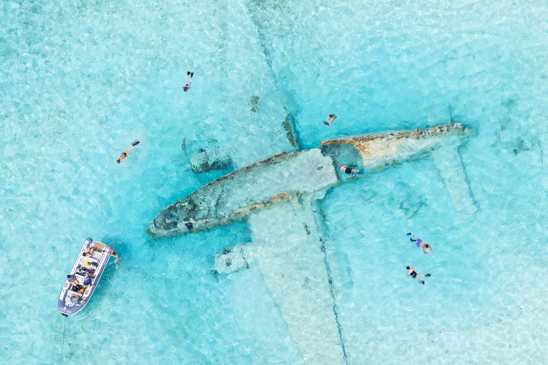 Photography by Gray Malin of Snorkeling Pablo Escobar's Plane Wreck, Norman’s Cay, Bahamas