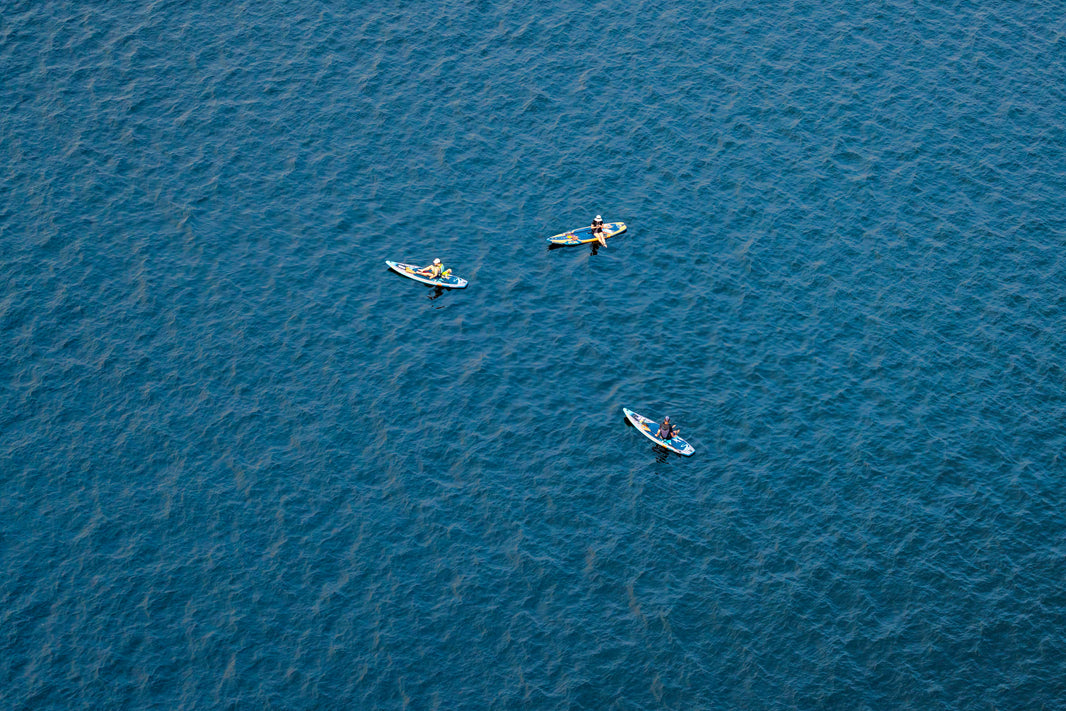 Photography by Gray Malin of Three Paddle Boarders, Lake Union, Seattle