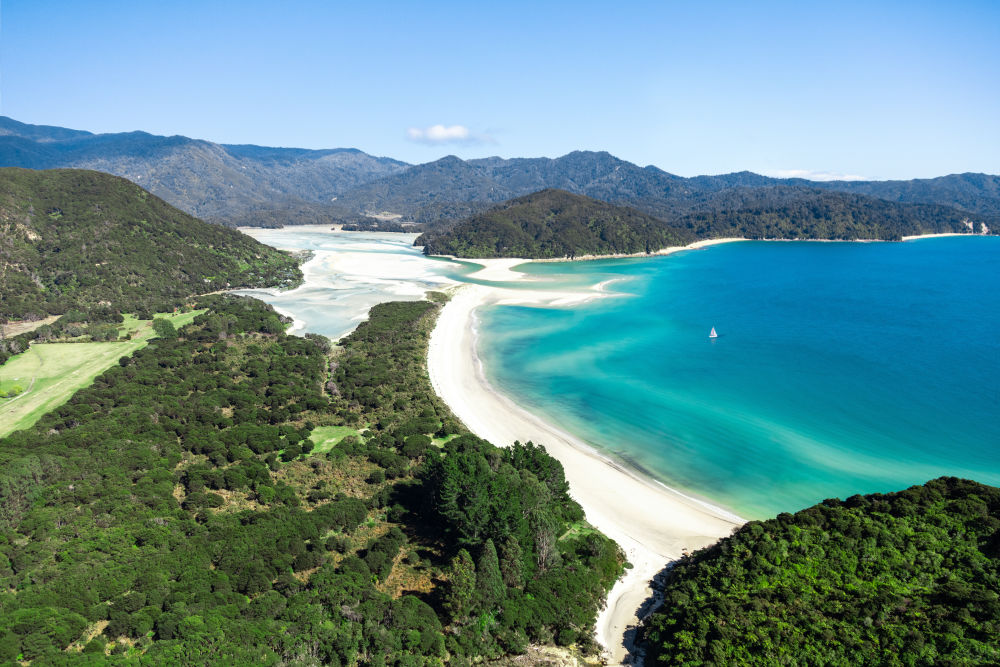 Photography by Gray Malin of Awaroa Bay Sailboat, Abel Tasman National Park, New Zealand