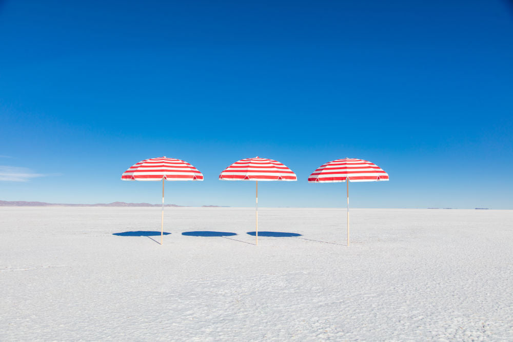 Photography by Gray Malin of Red and White Striped Umbrellas II
