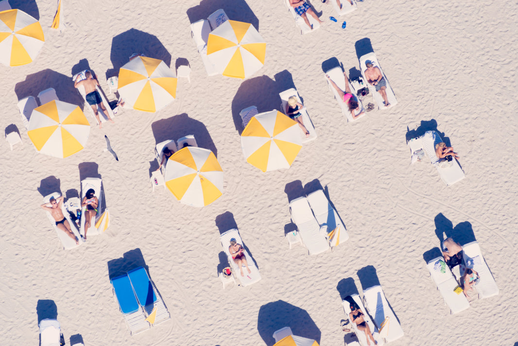 Photography by Gray Malin of Yellow and White Striped Umbrellas