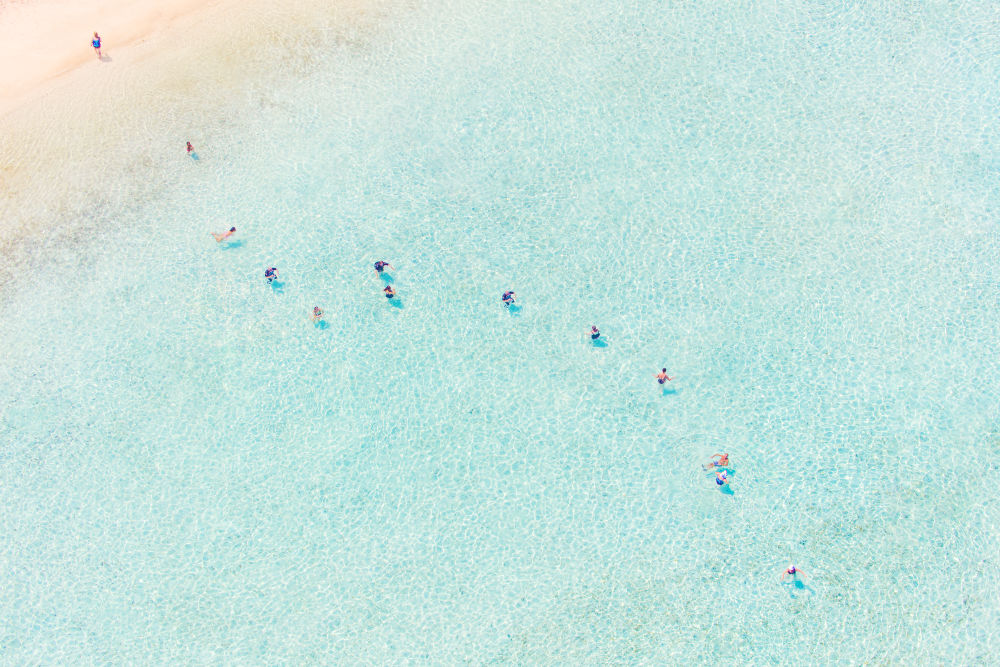 Photography by Gray Malin of Matira Beach Swimmers
