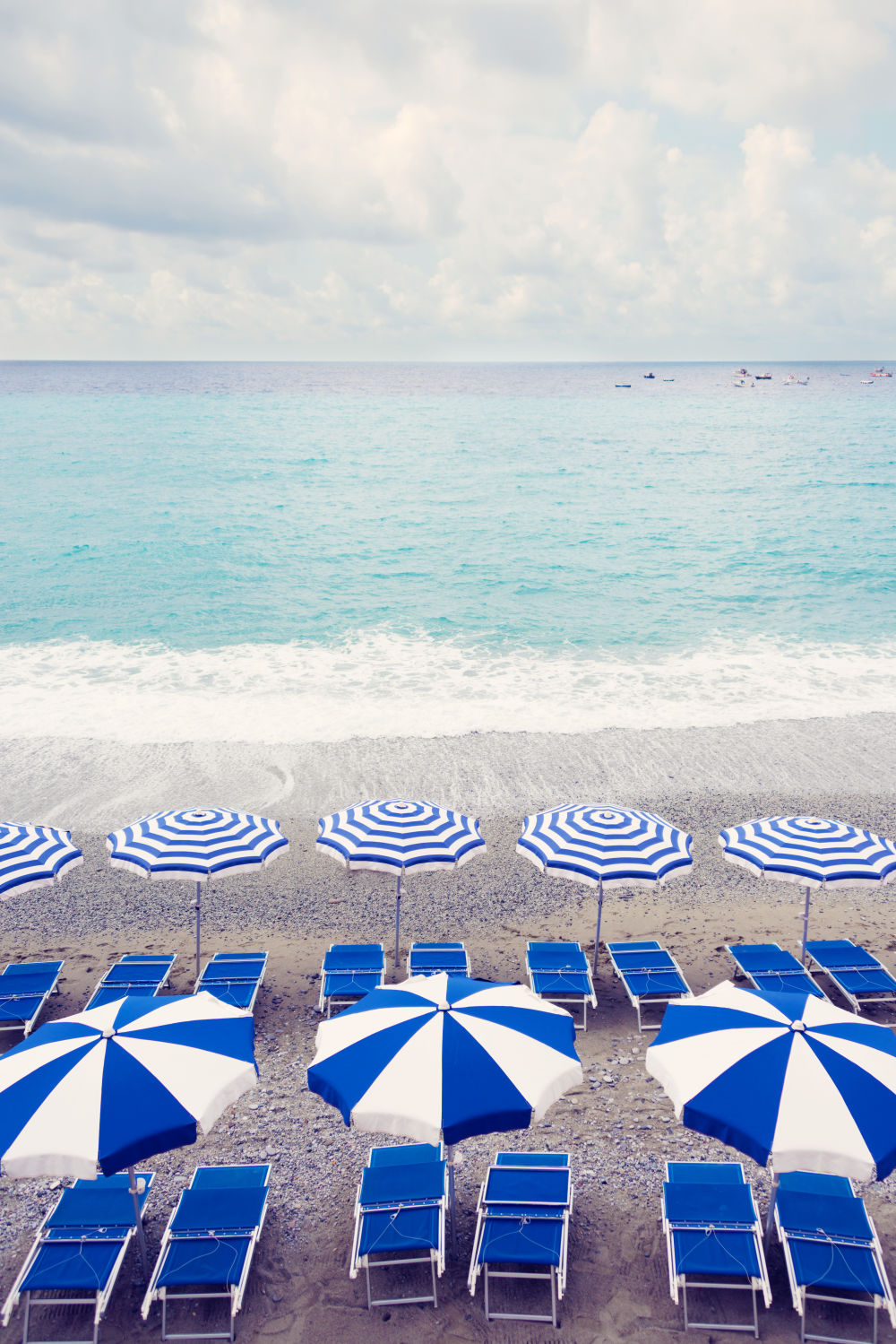 Photography by Gray Malin of Navy and White Striped Umbrellas Vertical