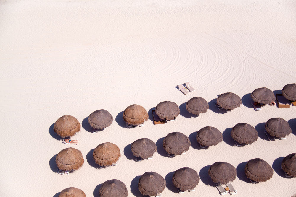 Photography by Gray Malin of Cancun Tiki Umbrellas, White Sand