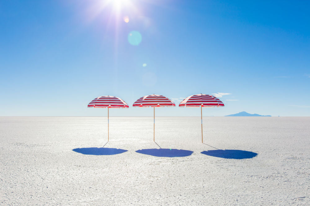 Photography by Gray Malin of Red and White Striped Umbrellas III