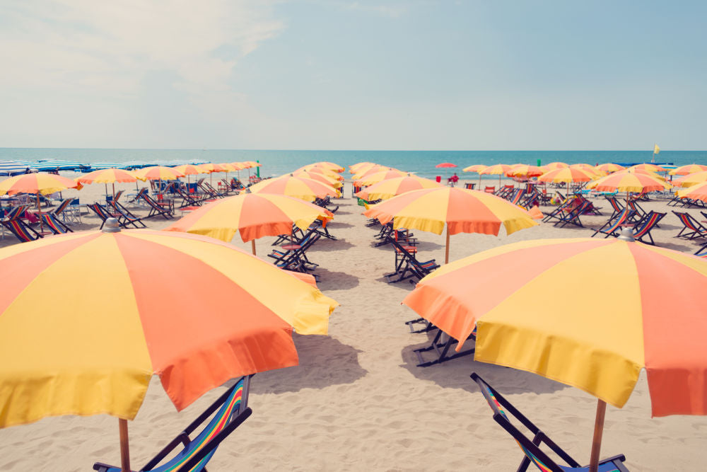 Photography by Gray Malin of Rivabella Orange and Yellow Umbrellas